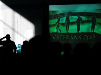 A veteran salutes the flag as a slideshow begins on a projector during the Roosevelt Middle School Veterans Day Assembly in New Bedford.   PETER PEREIRA/THE STANDARD-TIMES/SCMG